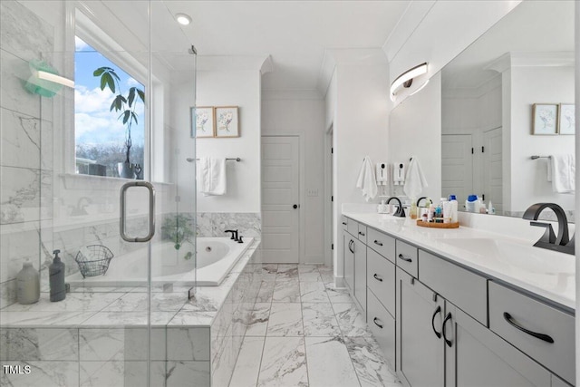 full bathroom featuring a garden tub, marble finish floor, ornamental molding, a sink, and a shower stall