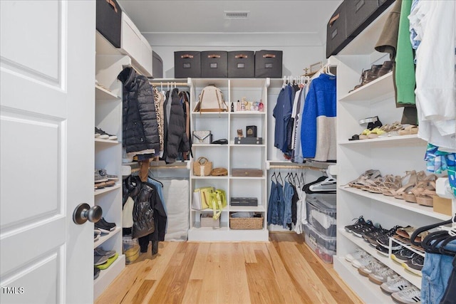 walk in closet with visible vents and wood finished floors