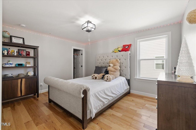 bedroom with baseboards and light wood-style floors