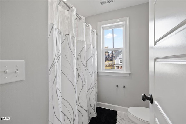 bathroom with visible vents, toilet, marble finish floor, a shower with curtain, and baseboards