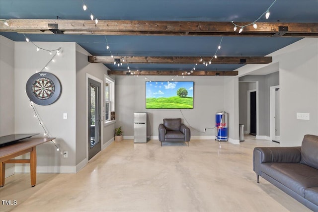 living area with baseboards, finished concrete flooring, and track lighting