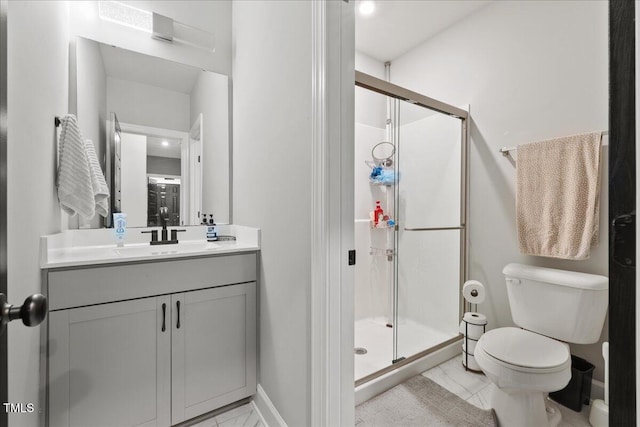 full bath featuring baseboards, vanity, toilet, and a shower stall