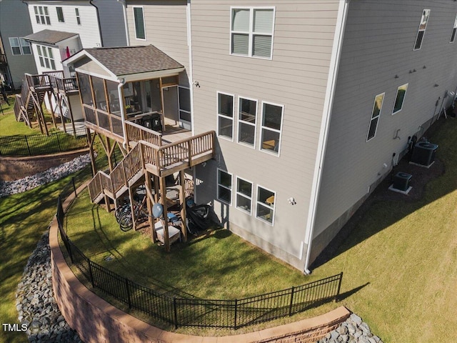 back of house with fence, stairway, central AC, a yard, and a sunroom