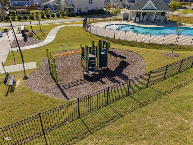 surrounding community featuring a swimming pool, fence, playground community, a yard, and a patio area