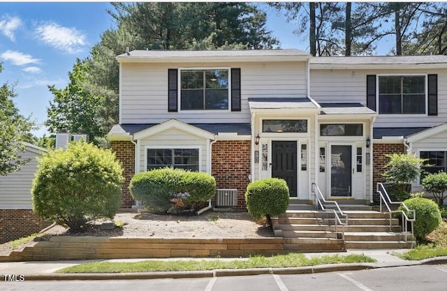 7708 Falcon Rest Cir, Raleigh, NC 27615 - view of front of house featuring brick siding, central AC unit, and uncovered parking