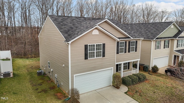 view of front facade featuring a front yard, a garage, central AC, and a shingled roof