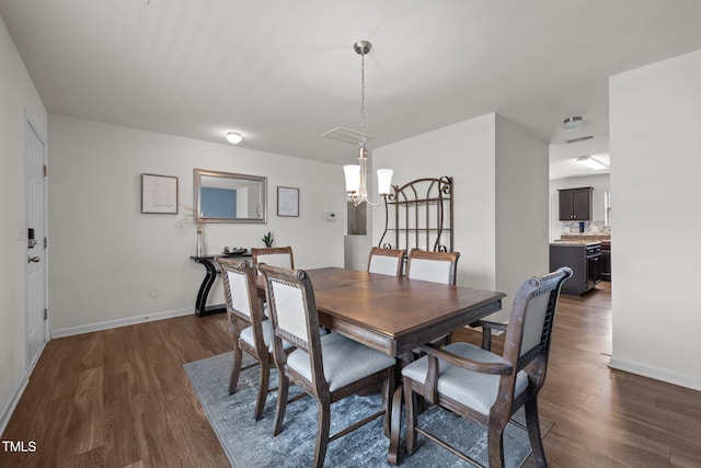 dining space with a notable chandelier, dark wood-style floors, and baseboards