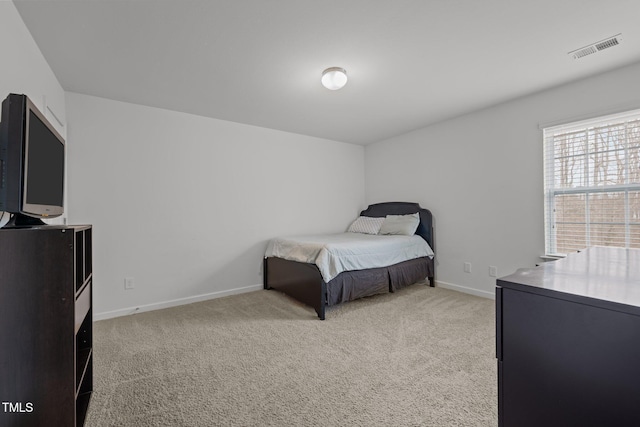 bedroom with visible vents, baseboards, and light colored carpet