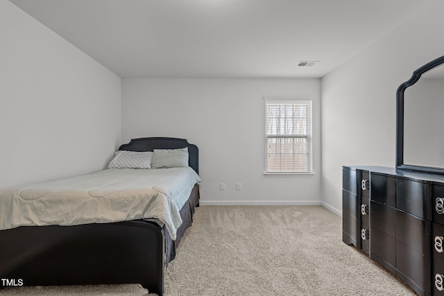 bedroom with visible vents, light carpet, and baseboards