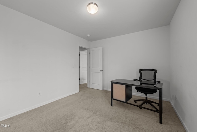 carpeted home office featuring baseboards