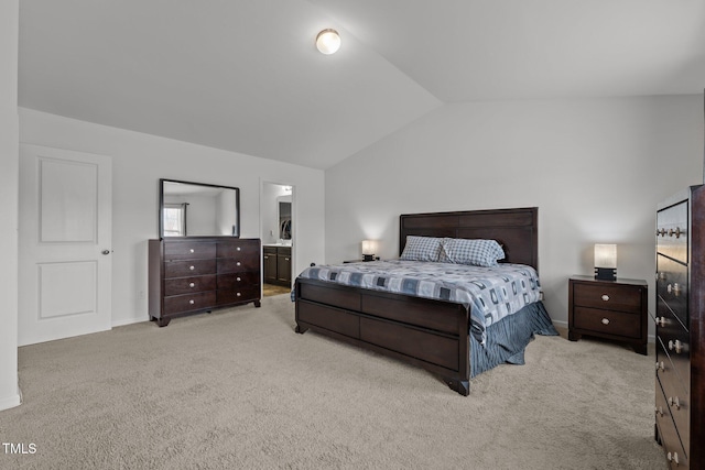 carpeted bedroom with vaulted ceiling and ensuite bathroom