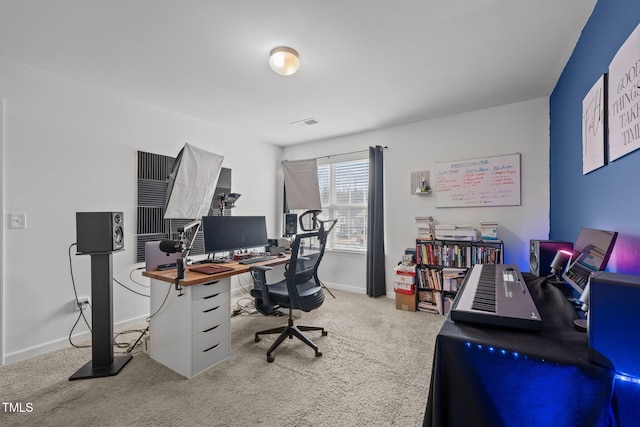 carpeted home office featuring visible vents and baseboards