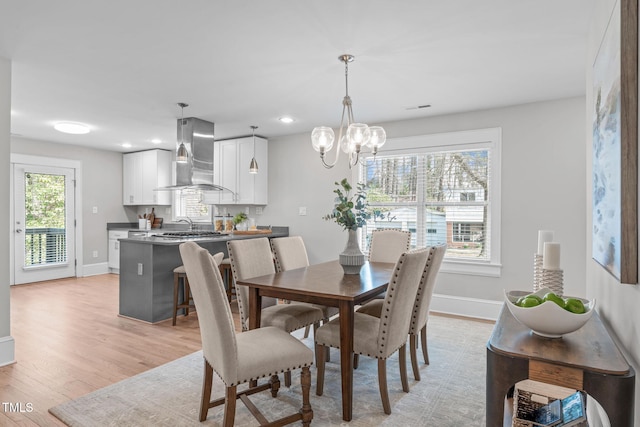 dining room featuring visible vents, baseboards, light wood finished floors, recessed lighting, and a notable chandelier