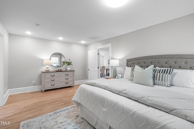 bedroom featuring visible vents, recessed lighting, wood finished floors, and baseboards