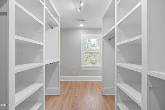 spacious closet with visible vents and wood finished floors