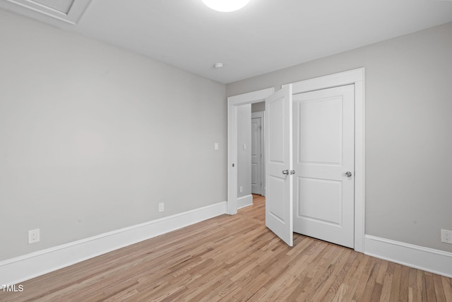 unfurnished bedroom featuring light wood-type flooring and baseboards