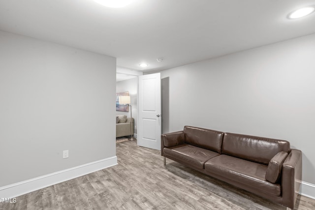 living room with recessed lighting, baseboards, and wood finished floors