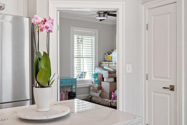 room details with crown molding, freestanding refrigerator, and ceiling fan