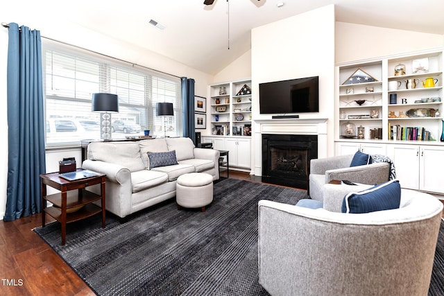 living area with visible vents, dark wood-type flooring, a fireplace with flush hearth, high vaulted ceiling, and a ceiling fan