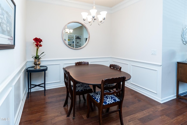 dining space featuring a decorative wall, a notable chandelier, wood finished floors, and ornamental molding