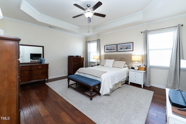 bedroom with visible vents, baseboards, dark wood-style flooring, crown molding, and a raised ceiling