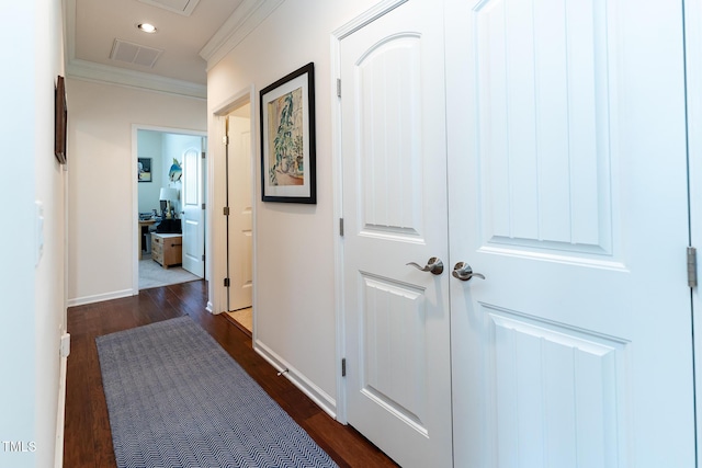 hallway with visible vents, dark wood-style floors, recessed lighting, crown molding, and baseboards