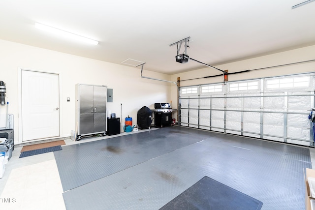 garage featuring electric panel and a garage door opener