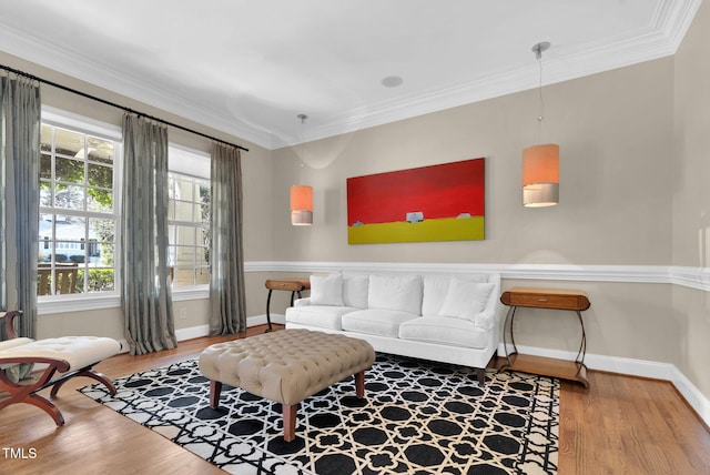 living room with ornamental molding, baseboards, and wood finished floors