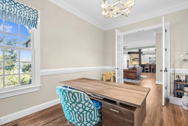 interior space with wood finished floors, baseboards, french doors, crown molding, and a notable chandelier