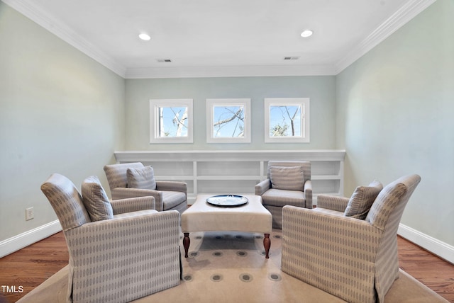 sitting room with plenty of natural light, wood finished floors, and visible vents