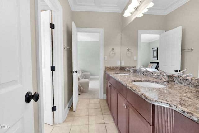 ensuite bathroom with tile patterned flooring, double vanity, ornamental molding, and a sink