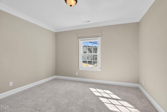 unfurnished room with crown molding, carpet, and baseboards