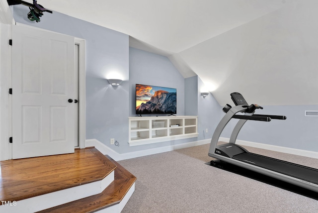 workout area with lofted ceiling, carpet, and baseboards