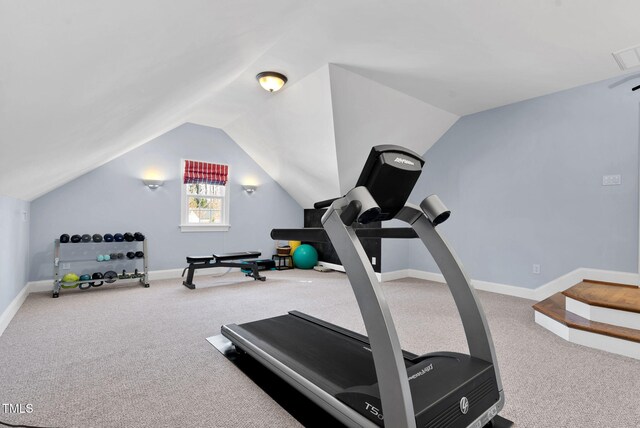 exercise room featuring lofted ceiling, carpet flooring, and baseboards