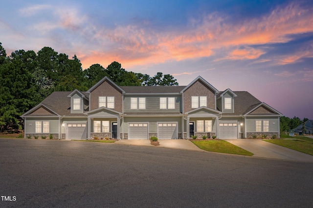 view of front facade featuring stone siding and driveway