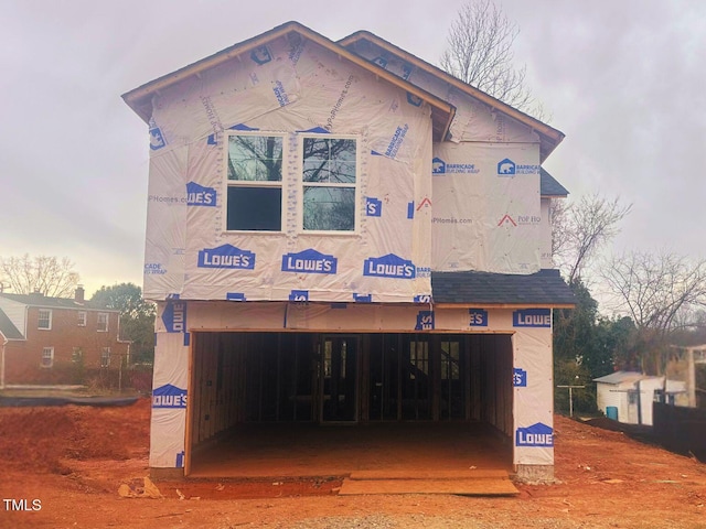 back of property with an attached garage