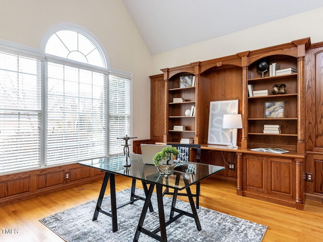 home office featuring light wood-style floors and high vaulted ceiling