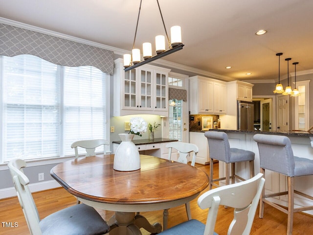 dining room with recessed lighting, baseboards, light wood-style floors, and ornamental molding