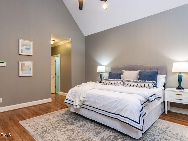 bedroom with ceiling fan, high vaulted ceiling, baseboards, and wood finished floors