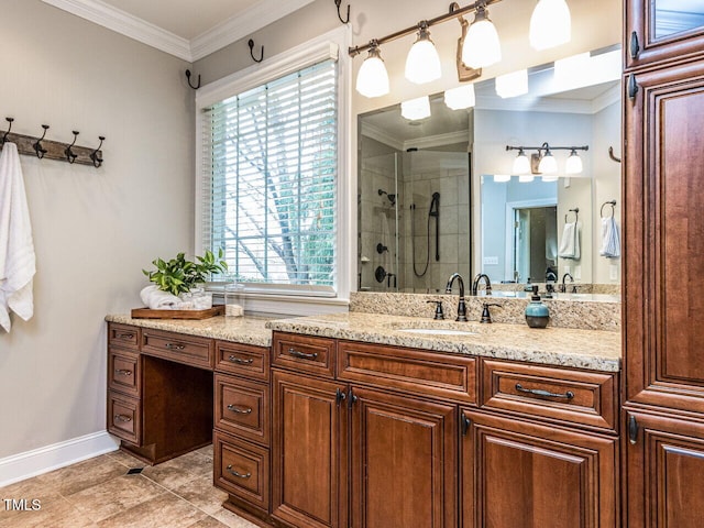 full bath with a stall shower, vanity, crown molding, and baseboards