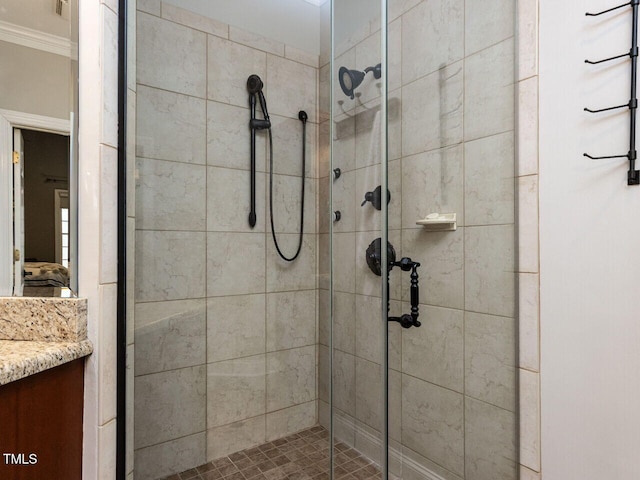 ensuite bathroom with ensuite bathroom, a stall shower, vanity, and crown molding