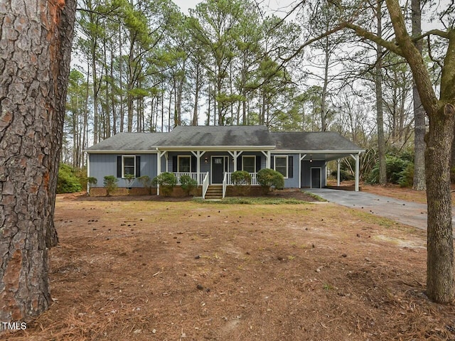 ranch-style home with a carport, covered porch, and concrete driveway