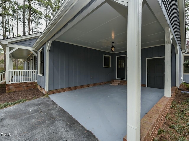 exterior space featuring entry steps, a carport, and covered porch