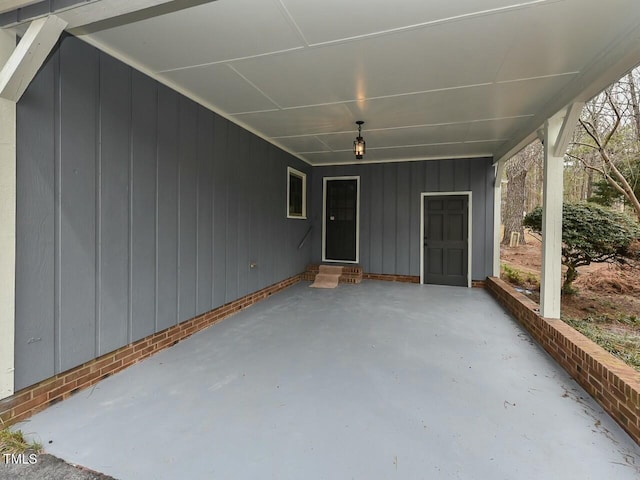 view of patio / terrace with entry steps and a carport