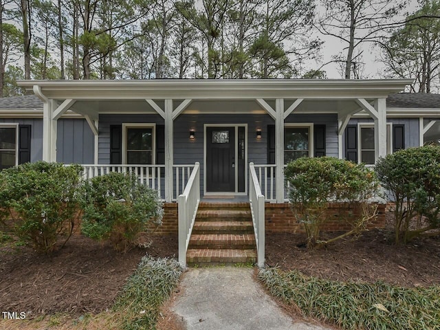 view of front of house with a porch and a shingled roof