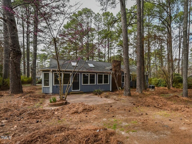 back of property with a sunroom