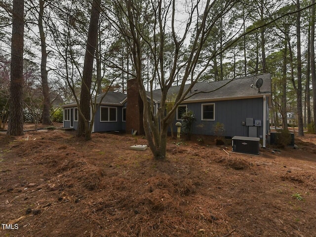 back of house with central air condition unit