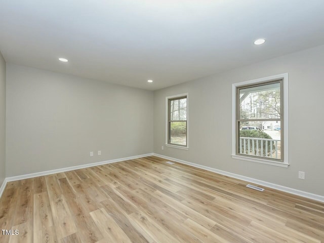 empty room with recessed lighting, baseboards, and light wood-style floors