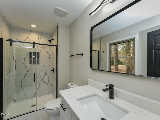 bathroom with a marble finish shower, toilet, marble finish floor, and vanity