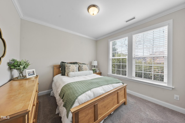 bedroom with crown molding, carpet flooring, baseboards, and visible vents